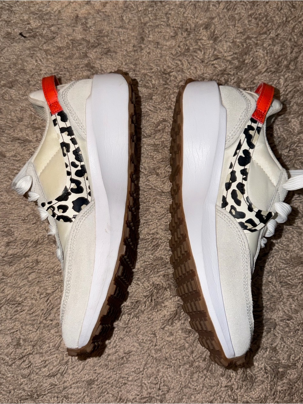 Nike Women's White Sneakers with Black Leopard Accents and Orange Pull Tab